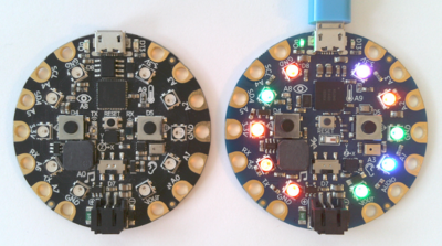 Hands connecting wires to a board